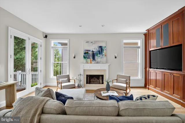 a living room with furniture flat screen tv and a fireplace