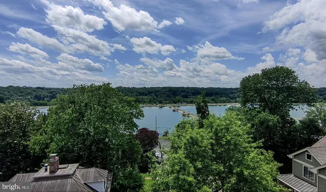 a view of a lake with table and chairs
