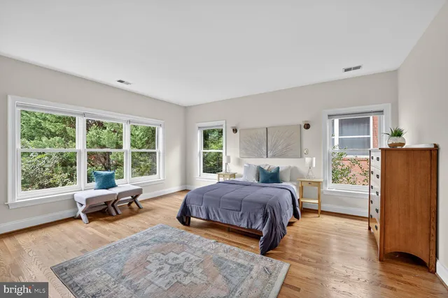 a living room with a bed furniture and a large window