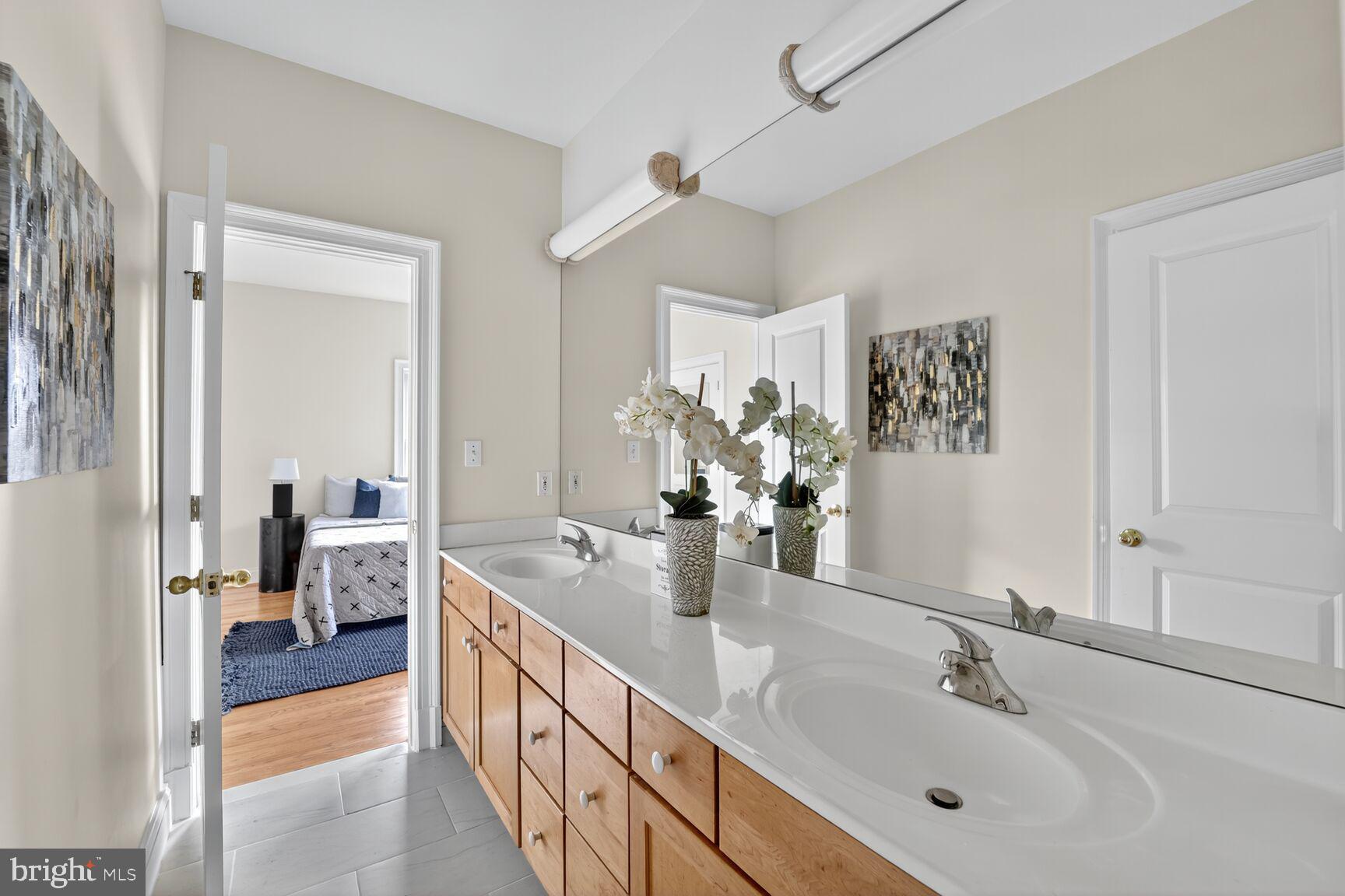 1829 47th Place Northwest Washington, DC 20007 - Photo 30 of 44 a en suite bathroom with double sink and a large mirror