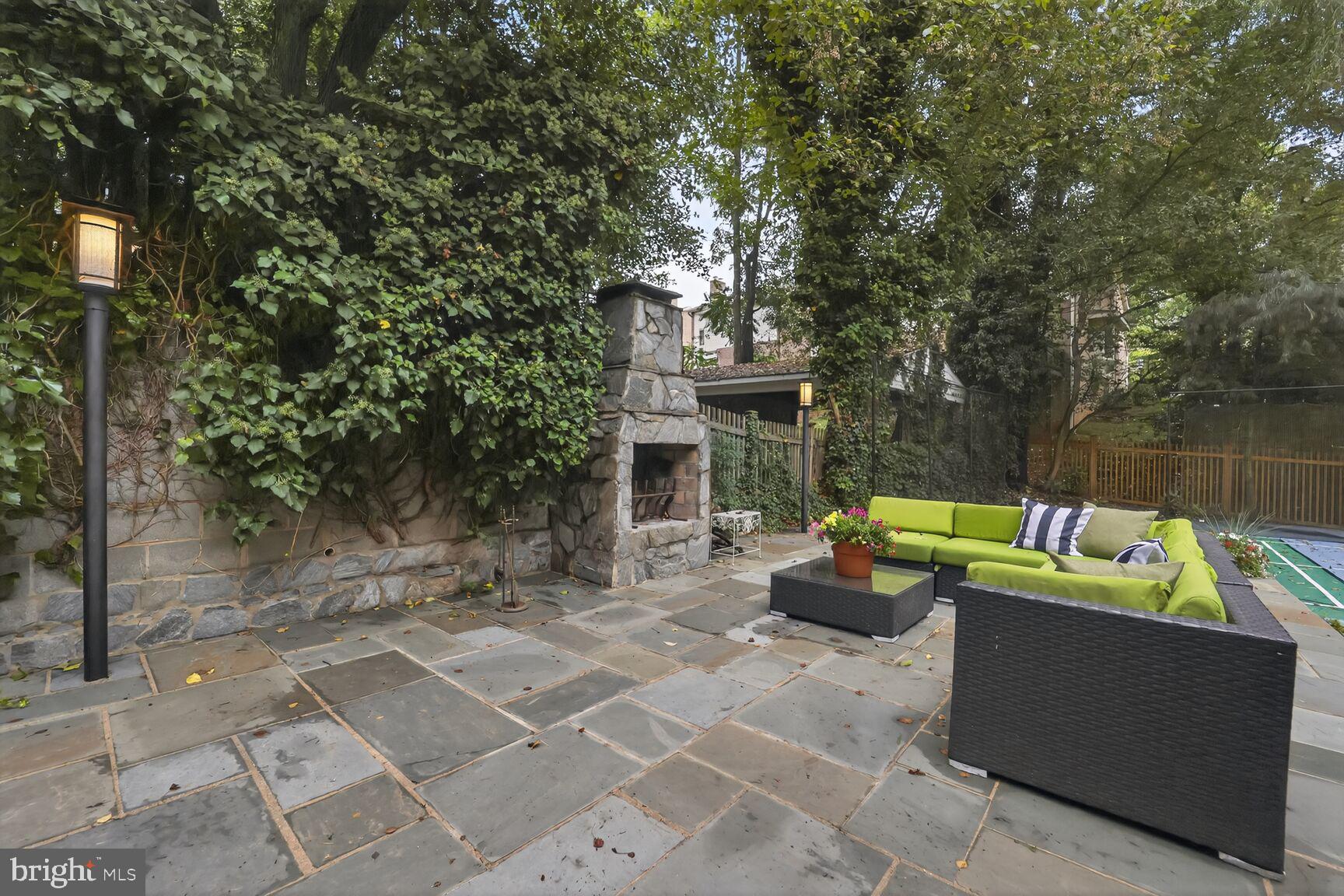 1829 47th Place Northwest Washington, DC 20007 - Photo 37 of 44 a view of a patio with couches plants and large trees