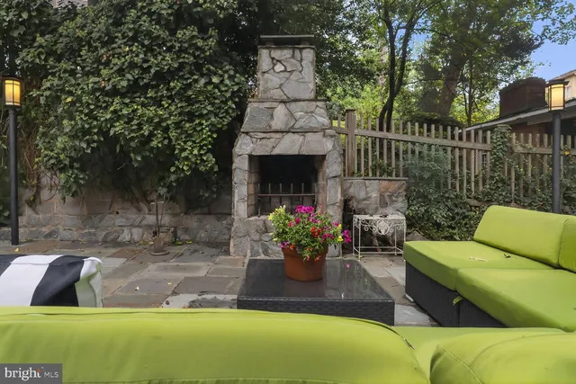 a view of a couches in the patio and a fountain