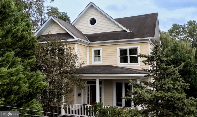 a front view of a house with plants