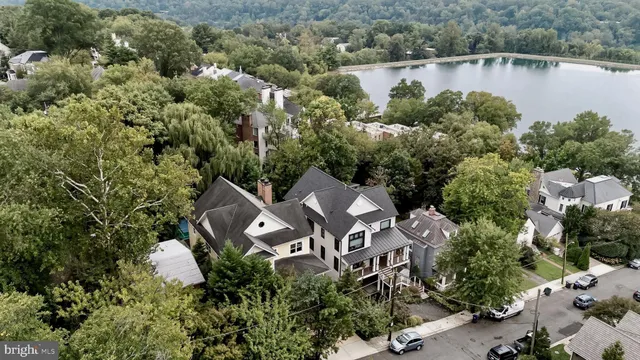 an aerial view of a house with a yard and lake view