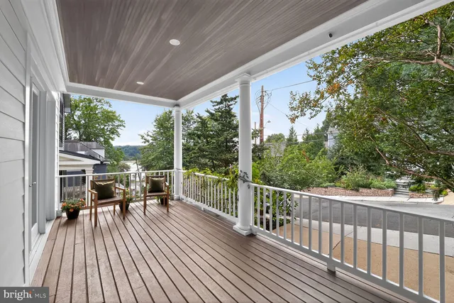a view of a chairs and table in patio with wooden floor