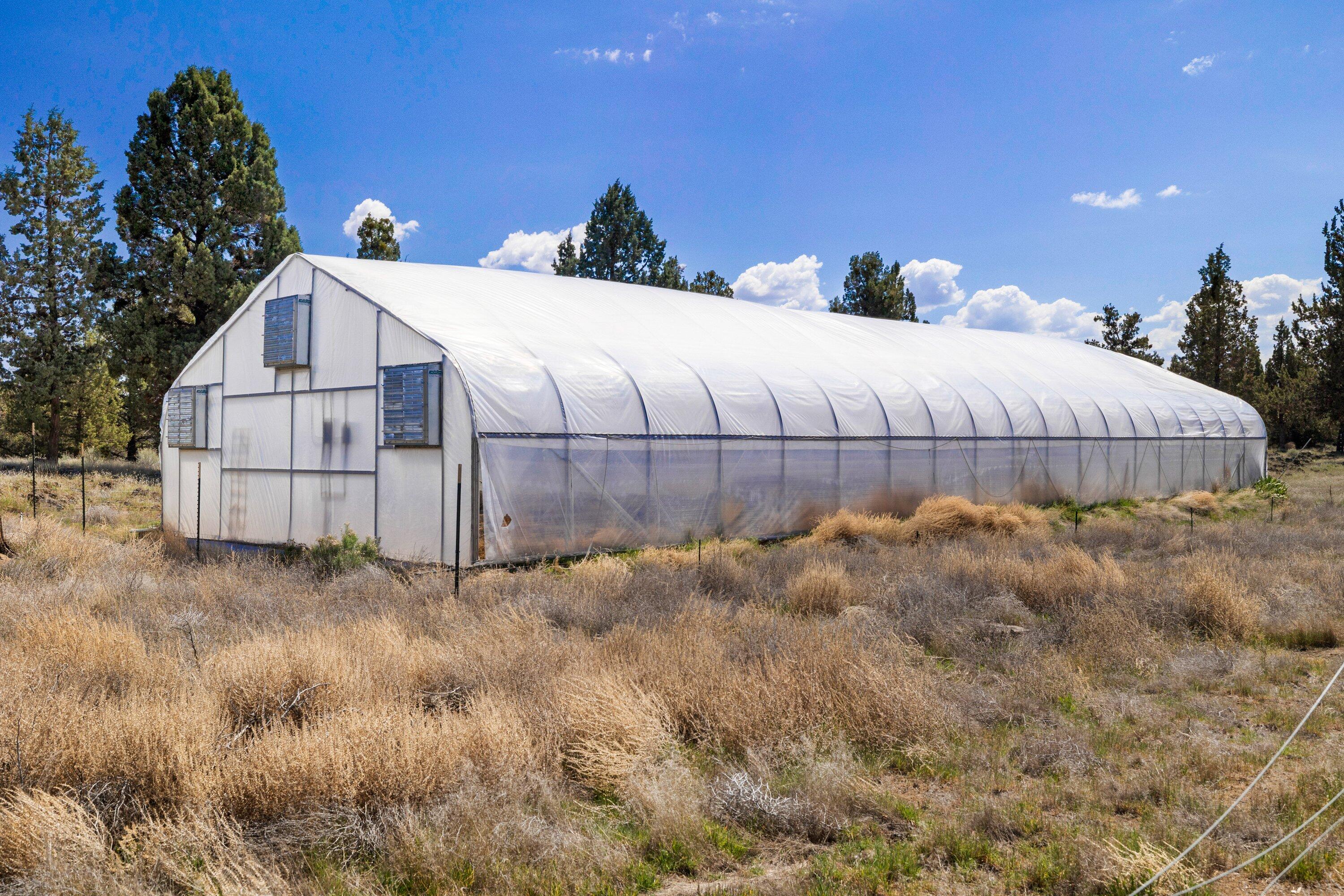 64155 Hunnell Road Bend, OR 97703 - Photo 75 of 96 Commercial grade self-contained greenhouse with gravel parking area.