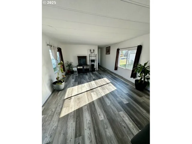 a view of a living room with furniture and a rug
