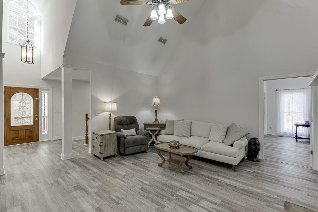 6360 Nix Road Dawsonville, GA 30534 - Photo 22 of 58 a living room with furniture and a chandelier