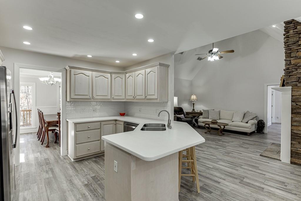 6360 Nix Road Dawsonville, GA 30534 - Photo 24 of 58 a kitchen with a sink a stove a refrigerator and cabinets