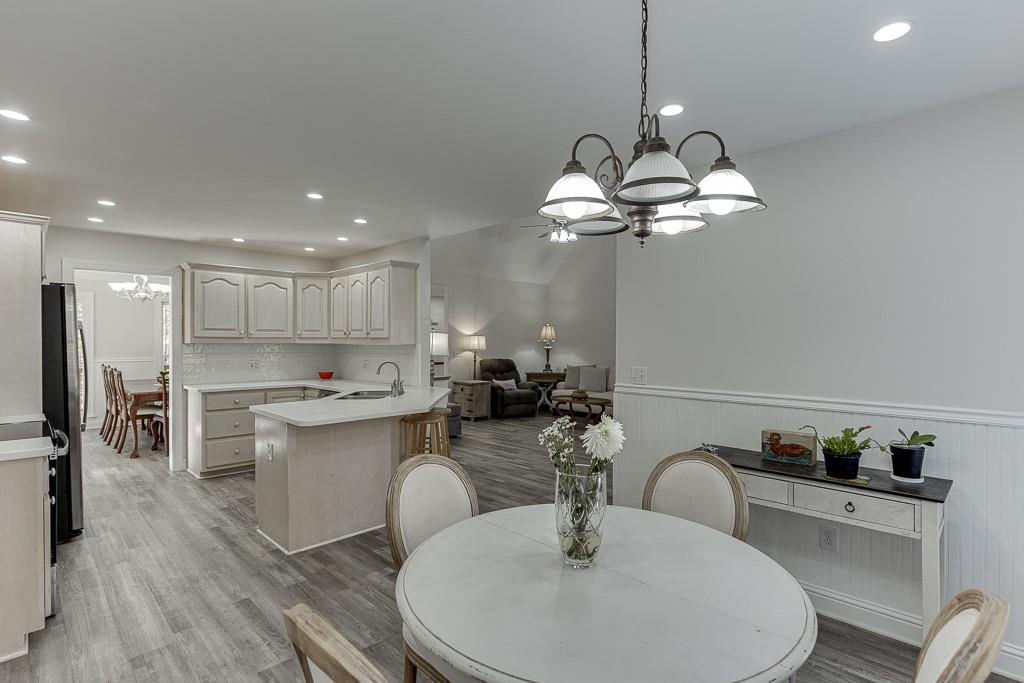 6360 Nix Road Dawsonville, GA 30534 - Photo 25 of 58 a kitchen with a dining table a sink stainless steel appliances and cabinets
