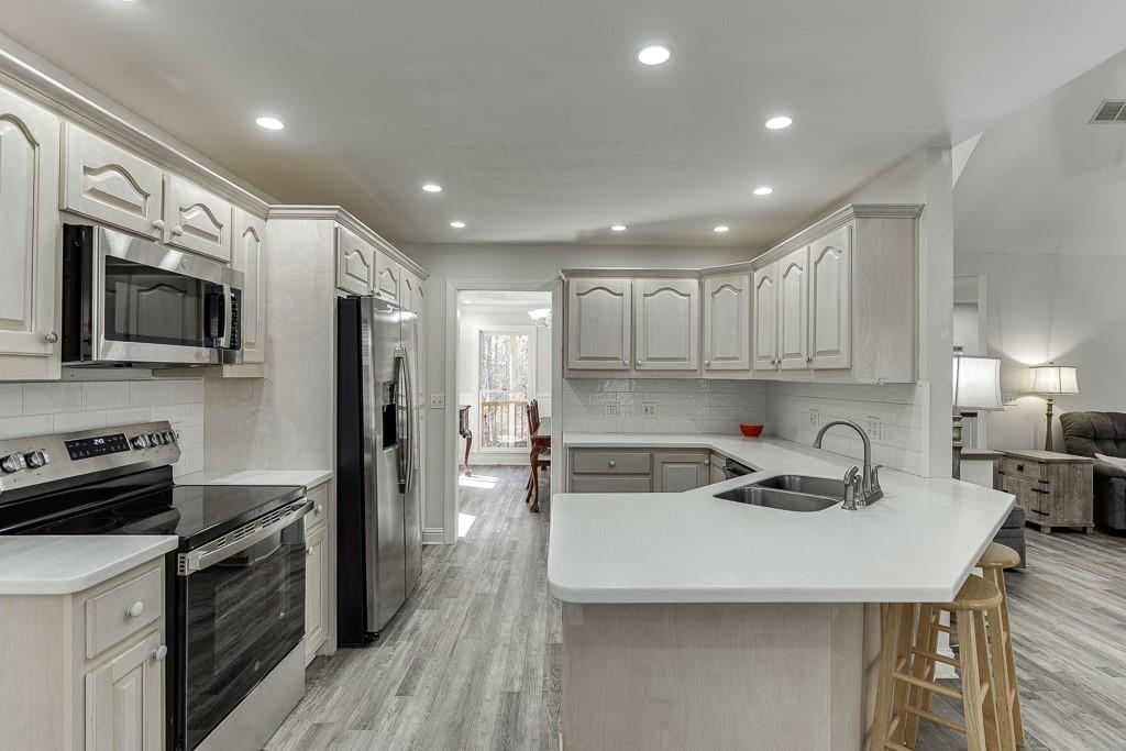 6360 Nix Road Dawsonville, GA 30534 - Photo 26 of 58 a kitchen with kitchen island a sink appliances and cabinets