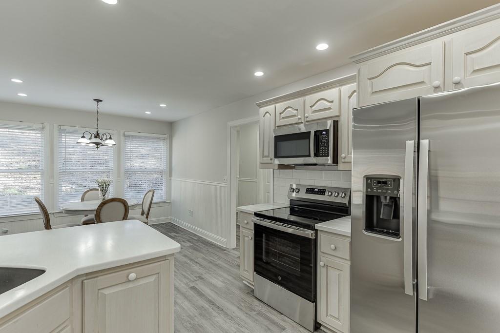 6360 Nix Road Dawsonville, GA 30534 - Photo 30 of 58 a kitchen with a sink stainless steel appliances and cabinets
