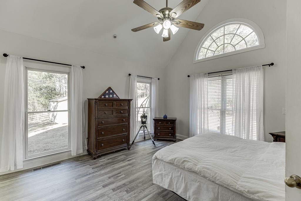 6360 Nix Road Dawsonville, GA 30534 - Photo 35 of 58 a bedroom with a bed and a chandelier