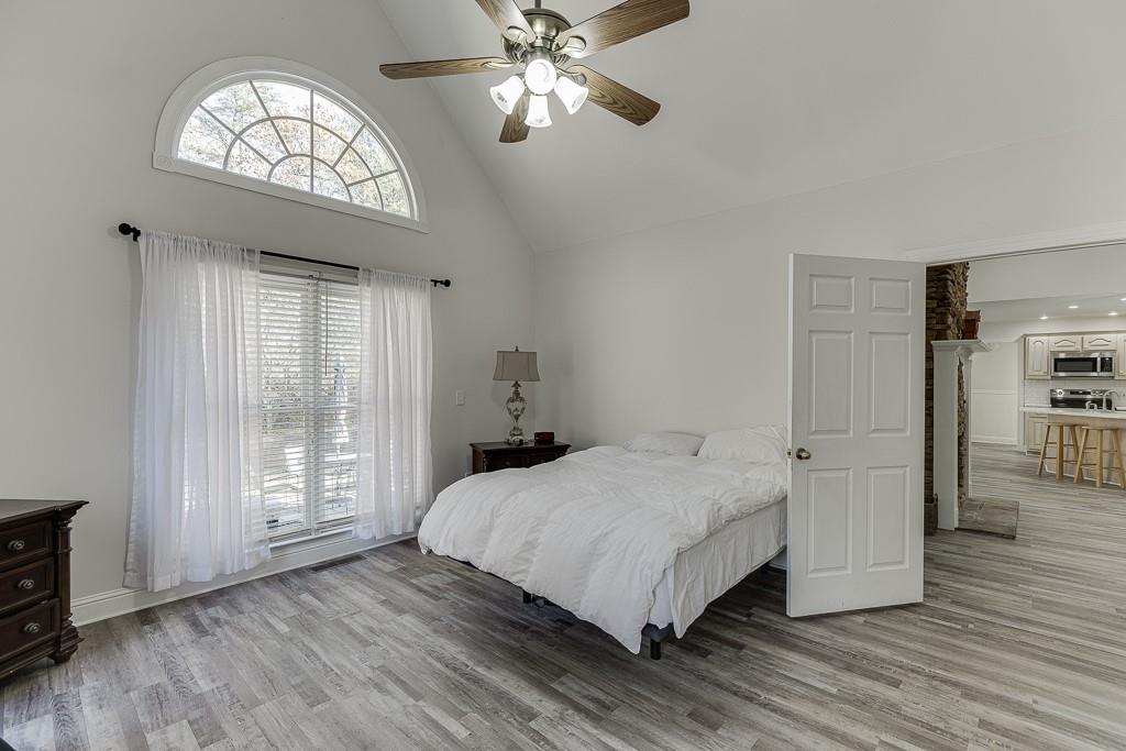 6360 Nix Road Dawsonville, GA 30534 - Photo 37 of 58 a bedroom with a large bed and a chandelier