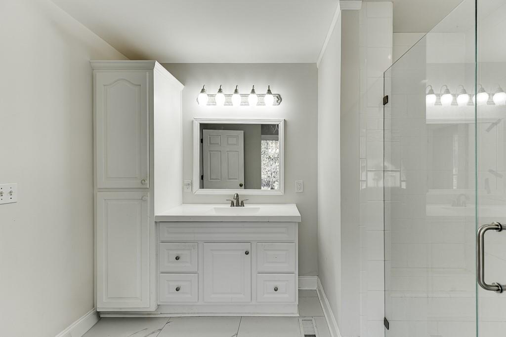 6360 Nix Road Dawsonville, GA 30534 - Photo 38 of 58 a bathroom with a double vanity sink and mirror