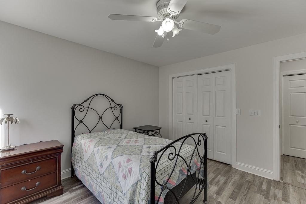 6360 Nix Road Dawsonville, GA 30534 - Photo 43 of 58 a bedroom with a bed and a chandelier