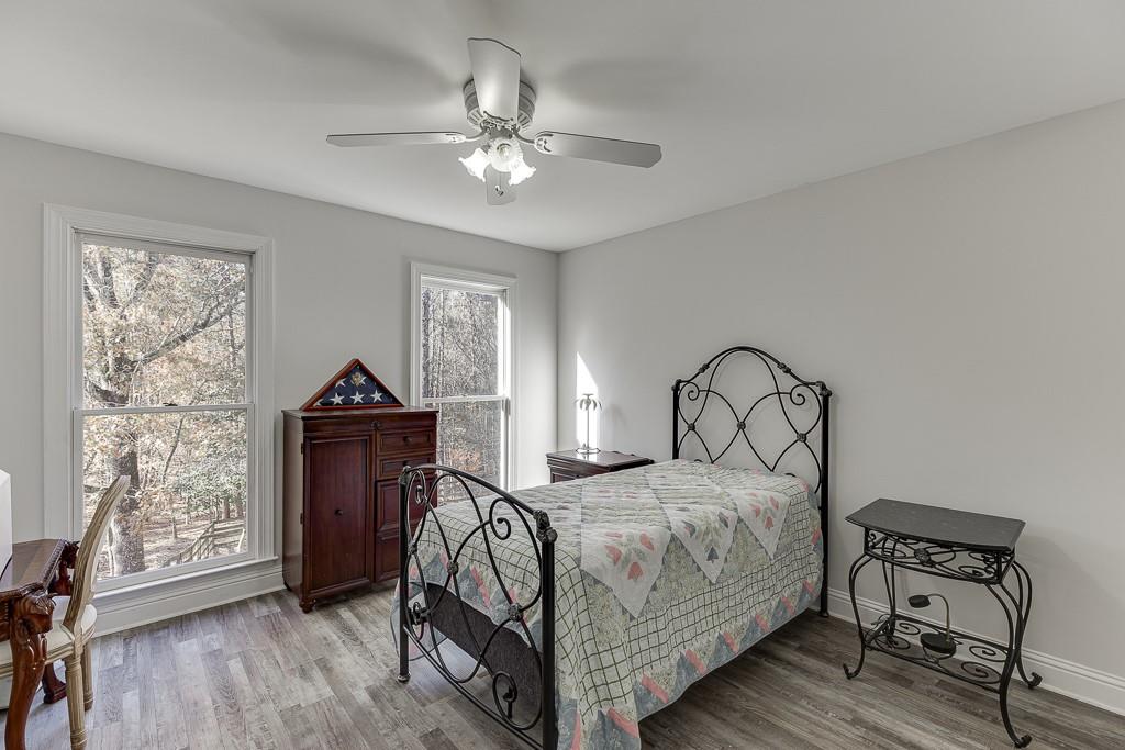 6360 Nix Road Dawsonville, GA 30534 - Photo 44 of 58 a bedroom with a bed and wooden floor