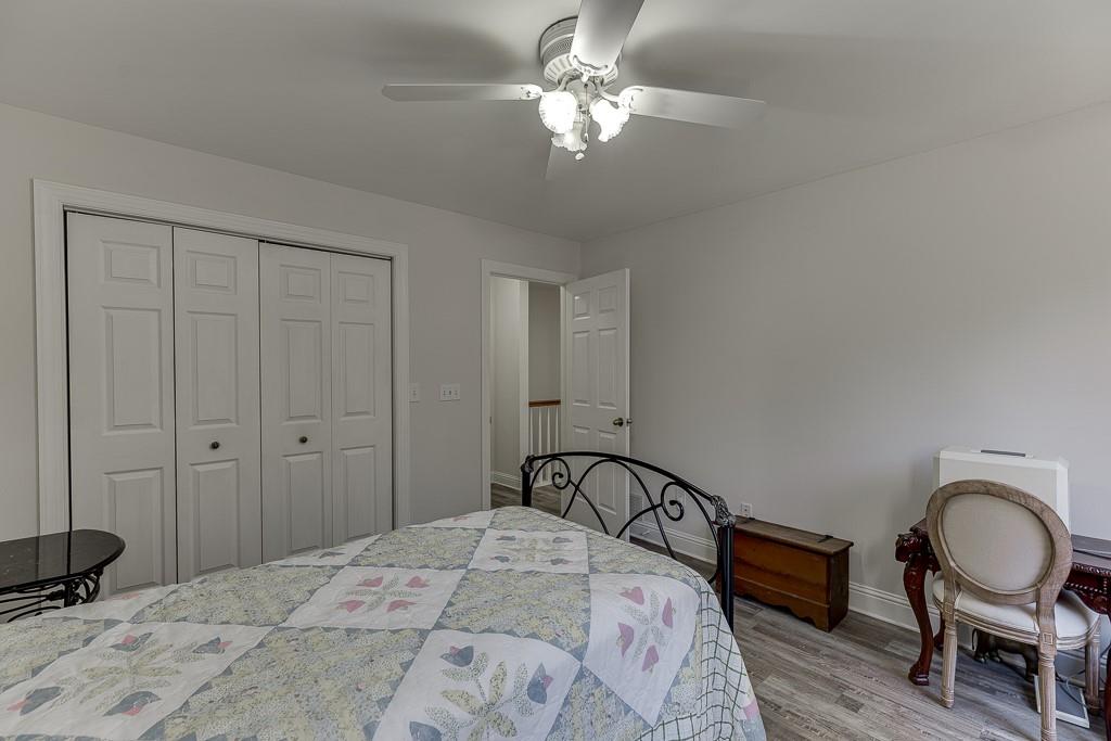 6360 Nix Road Dawsonville, GA 30534 - Photo 45 of 58 a bedroom with a bed and a chandelier