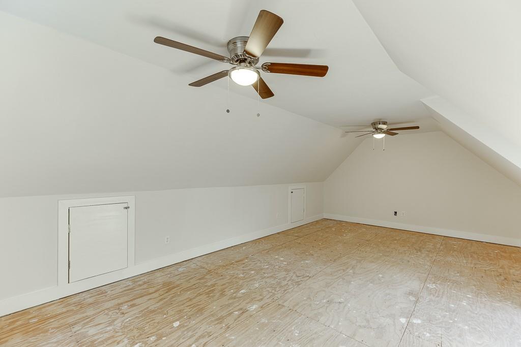 6360 Nix Road Dawsonville, GA 30534 - Photo 56 of 58 an empty room with a ceiling fan and wooden floor