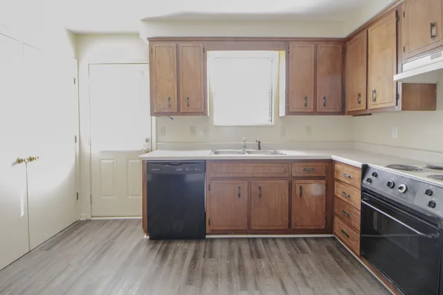 a kitchen with a sink stove and cabinets