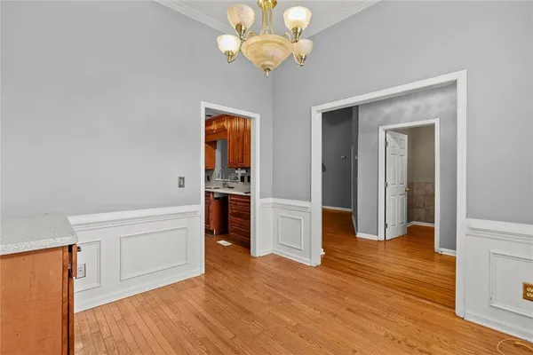 a view of a kitchen with wooden floor and a ceiling fan