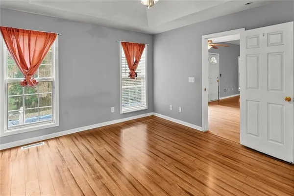 wooden floor in an empty room with a window