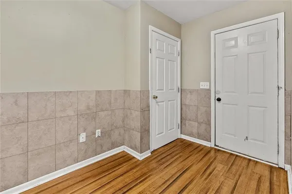 a view of a room with wooden floor and bathroom