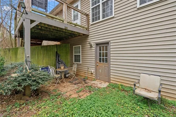 a backyard of a house with table and chairs