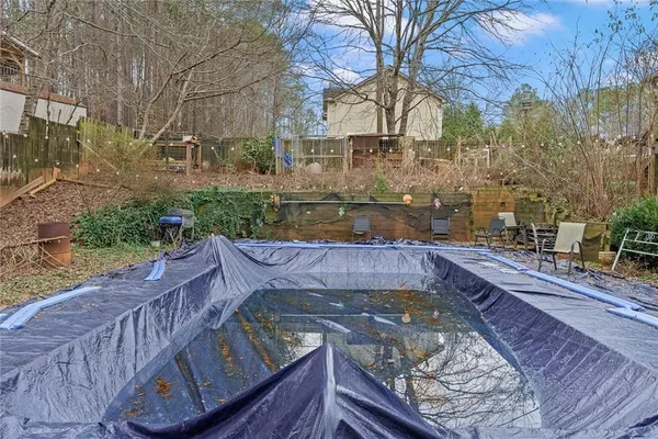 a view of a wooden deck and a patio with a yard