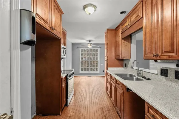 a kitchen with a sink stove and cabinets