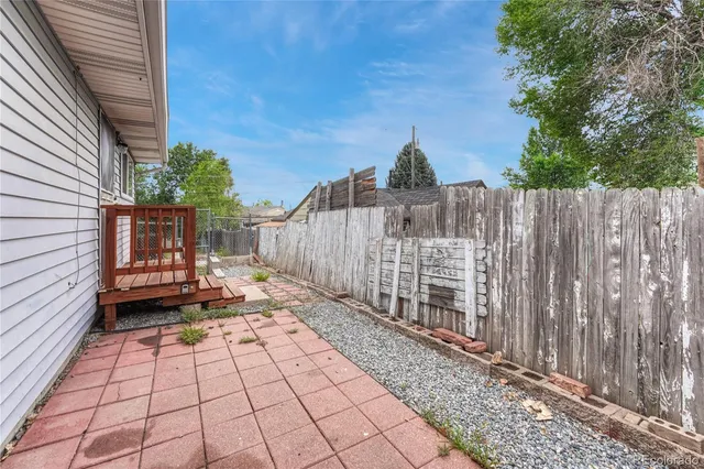 a view of a wooden fence with a trees