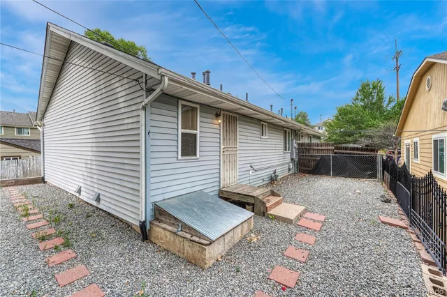 a view of a small house with wooden floor and potted plants