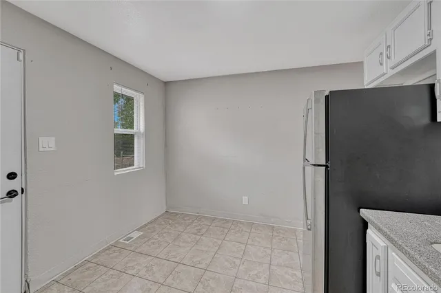 a view of a kitchen with an empty space and a window