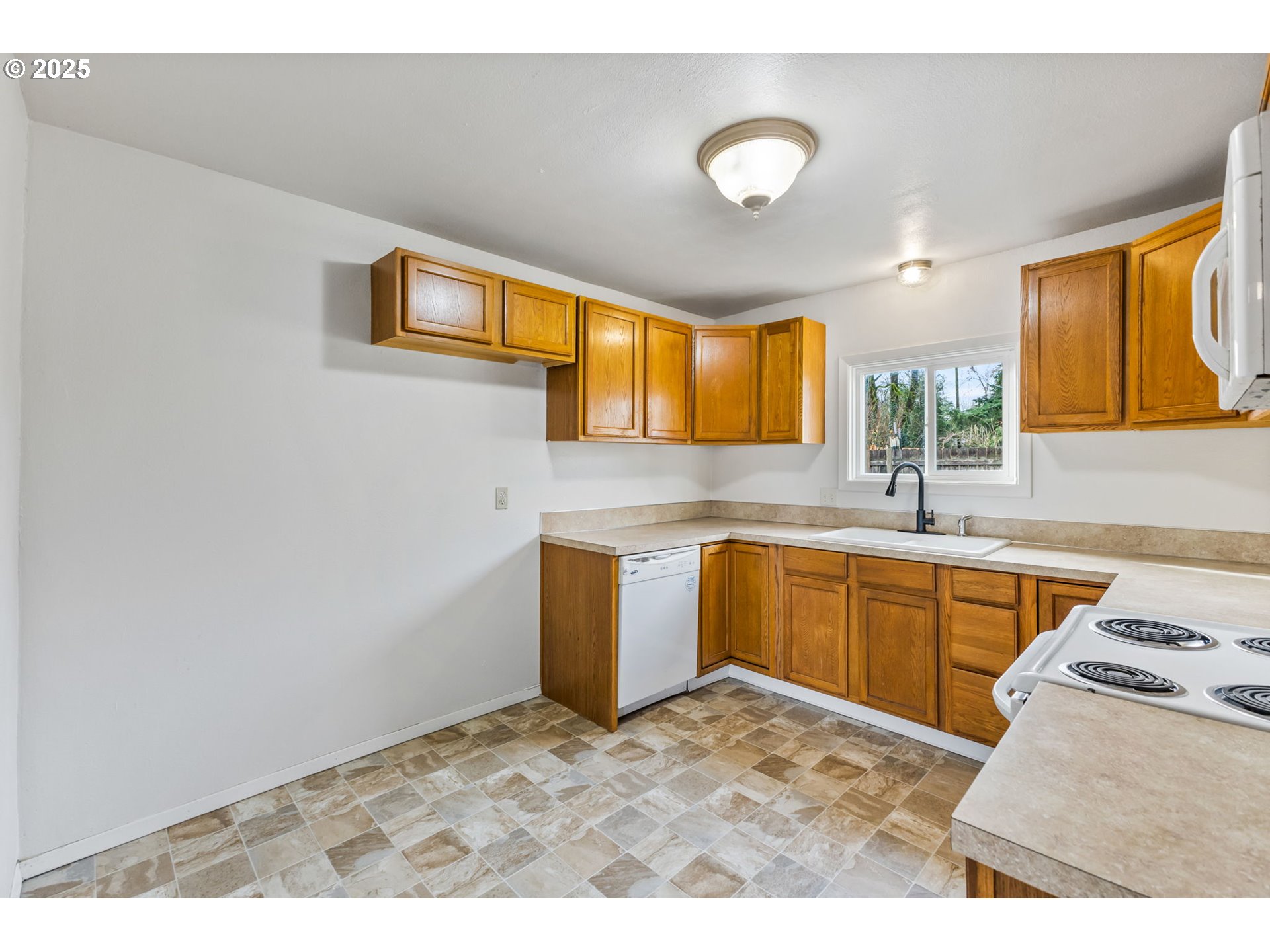 1141 Southeast Lewis Street Dallas, OR 97338 - Photo 8 of 20 a kitchen with a sink cabinets and window