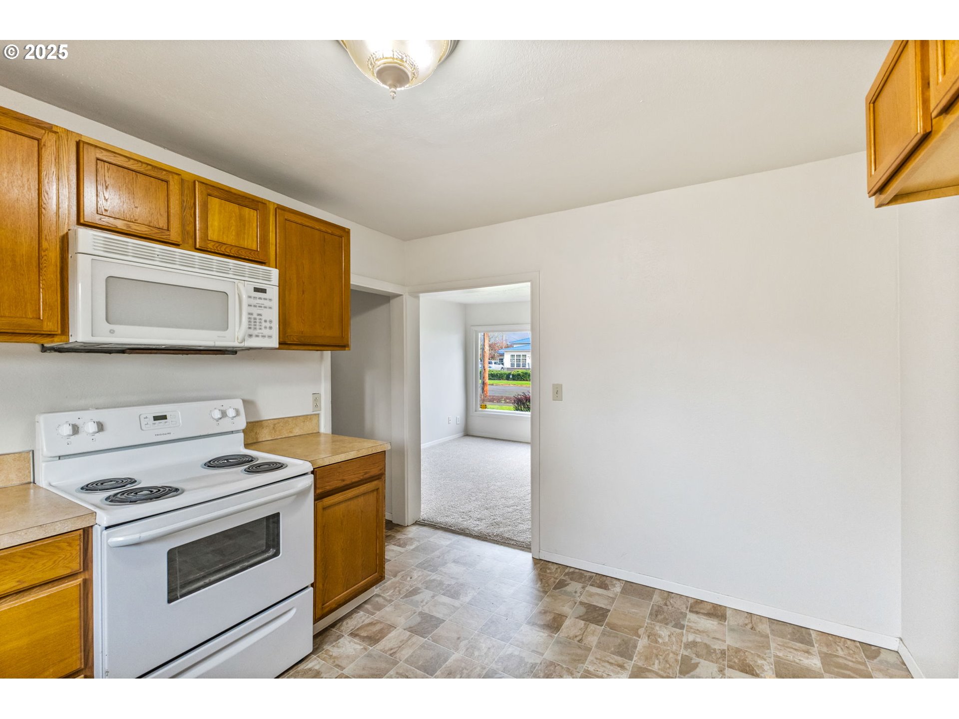 1141 Southeast Lewis Street Dallas, OR 97338 - Photo 10 of 20 a kitchen with a stove cabinets and a microwave