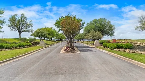 a view of a yard with large trees