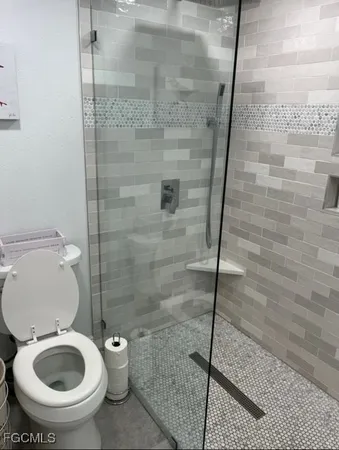 a bathroom with a toilet and a shower