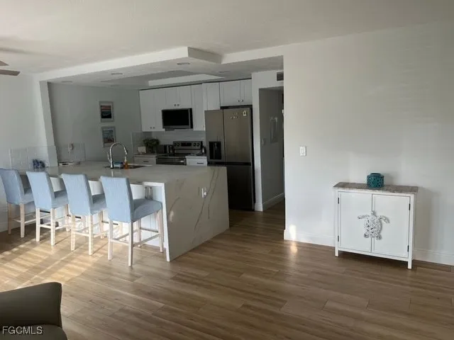a view of kitchen with furniture and wooden floor