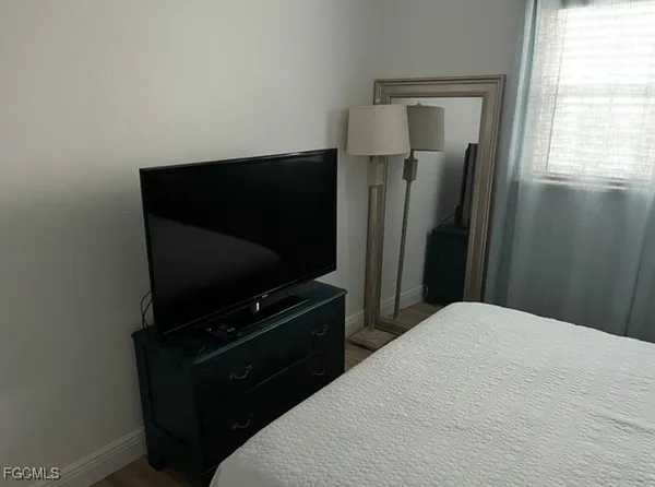 a bedroom with a bed and television