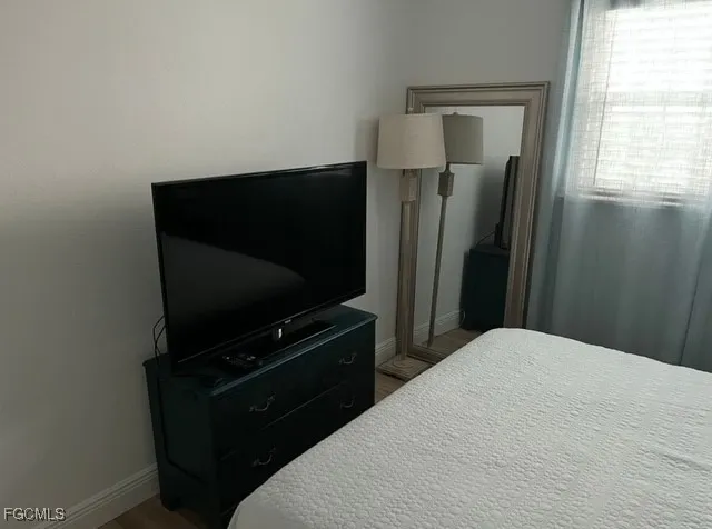 a bedroom with a bed and television