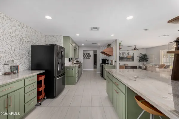 front view of a house with a yard and potted plants