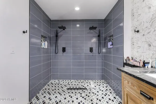a bathroom with a granite countertop sink a toilet and a mirror