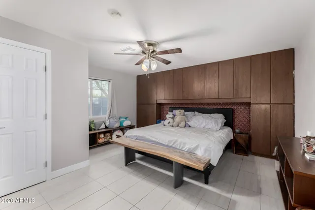 a bedroom with furniture and a flat screen tv