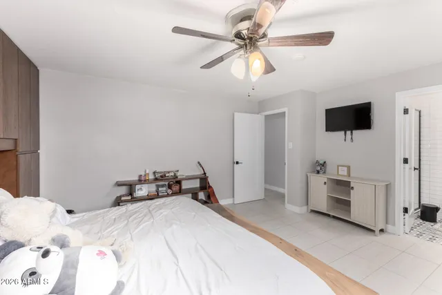 a bathroom with a granite countertop sink a toilet and a mirror