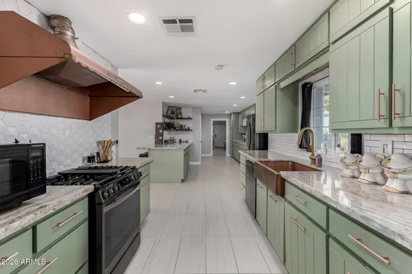 a kitchen with cabinets and chairs