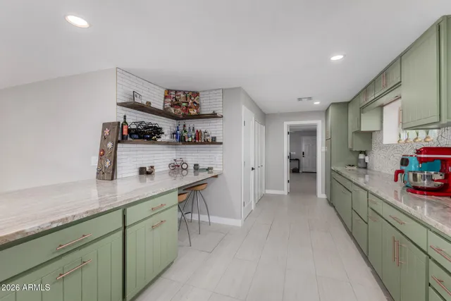 a kitchen with a sink dishwasher and cabinets with wooden floor