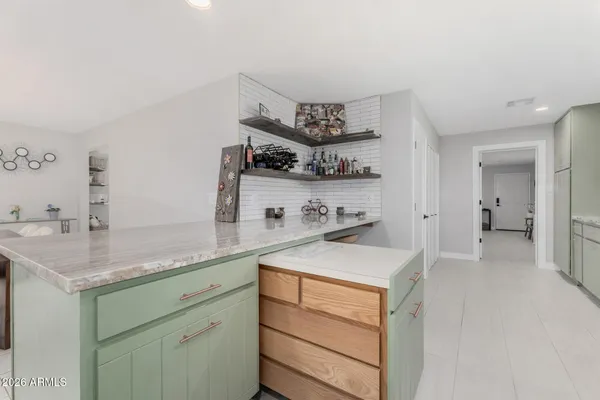 a kitchen with refrigerator and cabinets