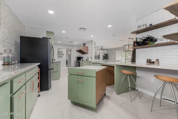 a kitchen with refrigerator and cabinets