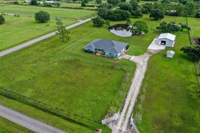 a view of a golf course with a wooden fence