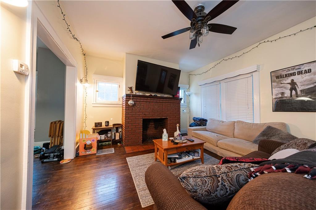 4263 Evergreen Road Pittsburgh, PA 15214 - Photo 2 of 28 a living room with furniture a fireplace and a flat screen tv